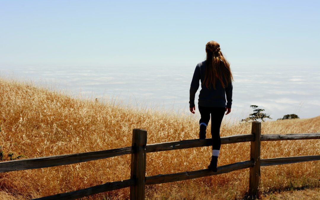 woman jump on brown fence